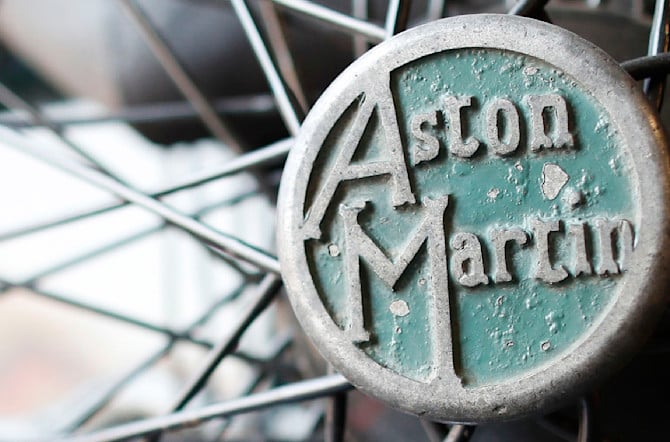 Close-up detail of the Aston Martin logo on the wheel of the Green Pea.