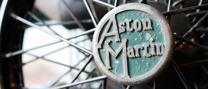 Close-up detail of the Aston Martin logo on the wheel of the Green Pea.