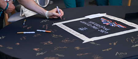 Guests sign the AMR car cover