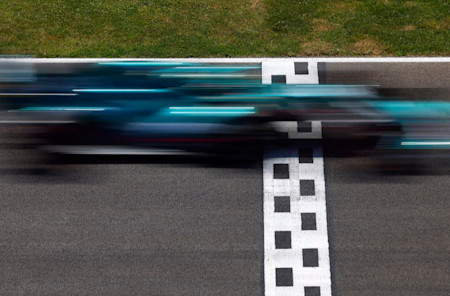 The AMR21 crosses the line at high speed