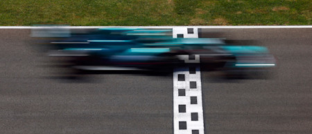 The AMR21 crosses the line at high speed