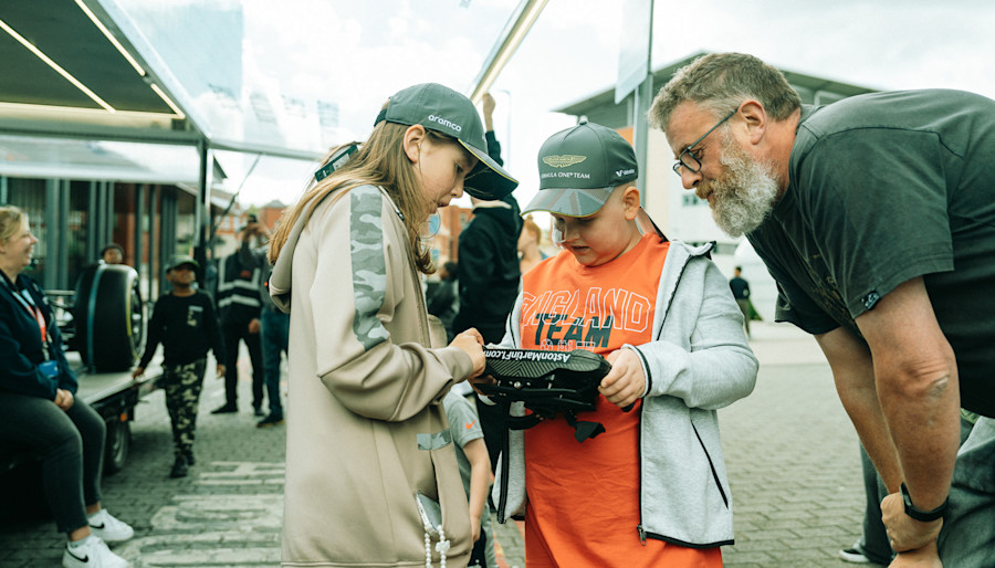 An unforgettable moment. Jozef gets his hands on the steering wheel of an Aston Martin Aramco F1 car.