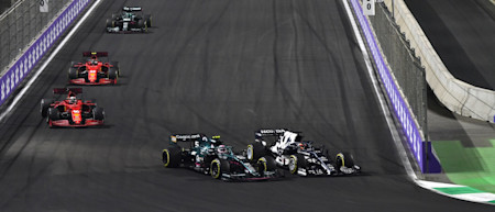 Sebastian holds off Yuki Tsunoda, who later collided with Sebastian