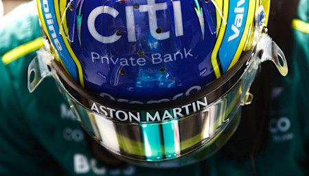 Fernando climbs into the cockpit of the AMR24