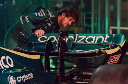 Sebastian Vettel closely examines the AMR22 following its global reveal