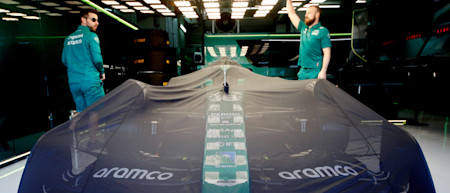 Rise and shine: the team lifts the covers off the AMR22 on race day