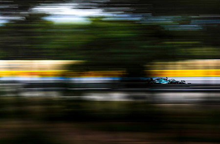 All a blur: Lance powers past the trees in practice