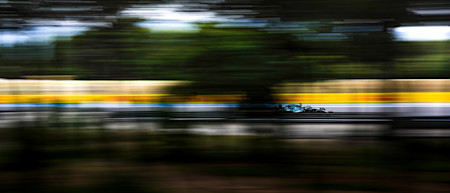 All a blur: Lance powers past the trees in practice