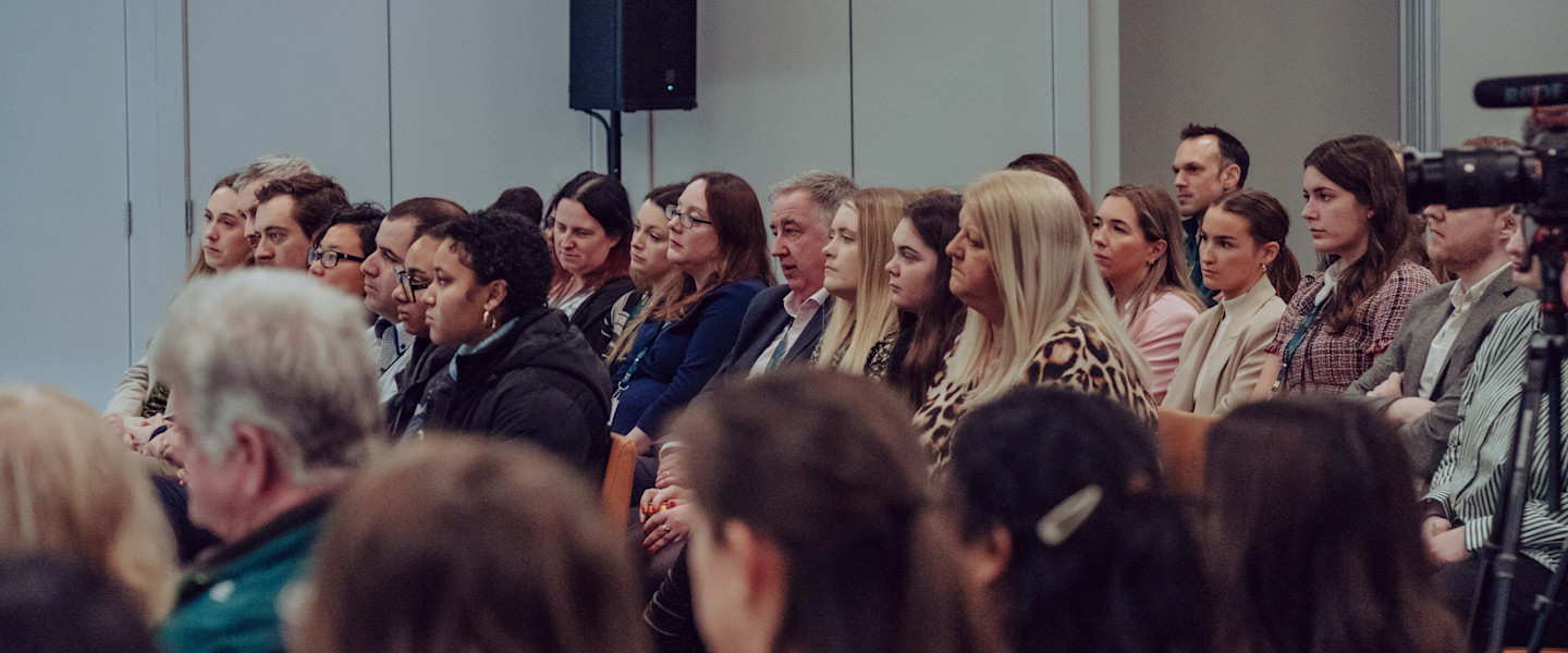 The audience listens to the panel's experiences