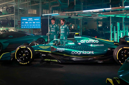 Lance Stroll and Sebastian Vettel stand proudly by the AMR22 following its reveal