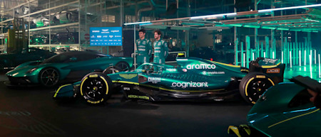Lance Stroll and Sebastian Vettel stand proudly by the AMR22 following its reveal