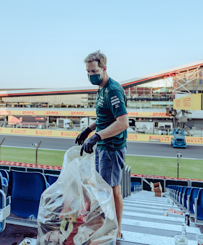 Sebastian picks up litter following the British Grand Prix