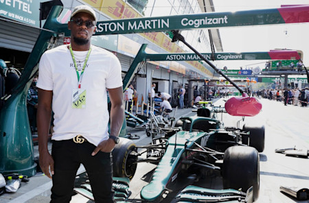 REPLAY Ambassador Usain Bolt with the AMR21