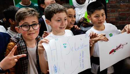 Students greeted Sebastian and were excited to share their F1 drawings