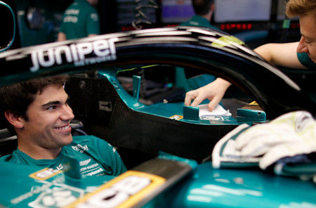 Lance shares a joke with his mechanic in the garage