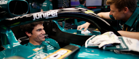 Lance shares a joke with his mechanic in the garage