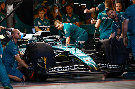 Lance's pit crew prime themselves to release the Canadian from the garage