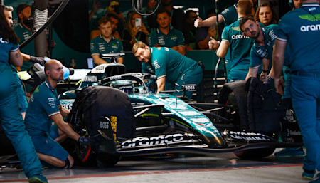 Lance's pit crew prime themselves to release the Canadian from the garage