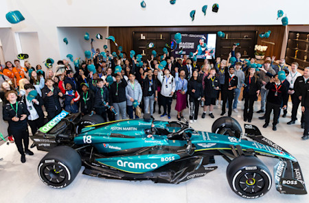 One for the photo album. Students gathered by our F1 car for a memorable photo after seeing the car up close.