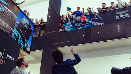 Some of the crowd pick up a special memento of the day as Lance throws signed caps to them