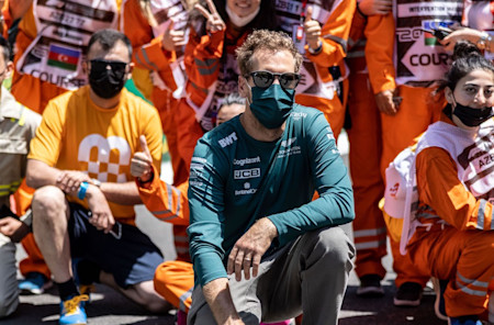 Sebastian takes a photo with marshals in Baku, thanking them for their tireless work