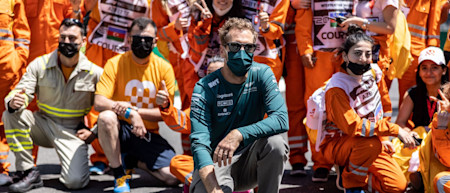 Sebastian takes a photo with marshals in Baku, thanking them for their tireless work