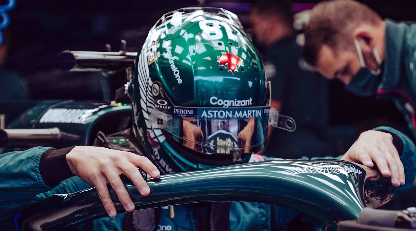 Lance Stroll climbs into the AMR21