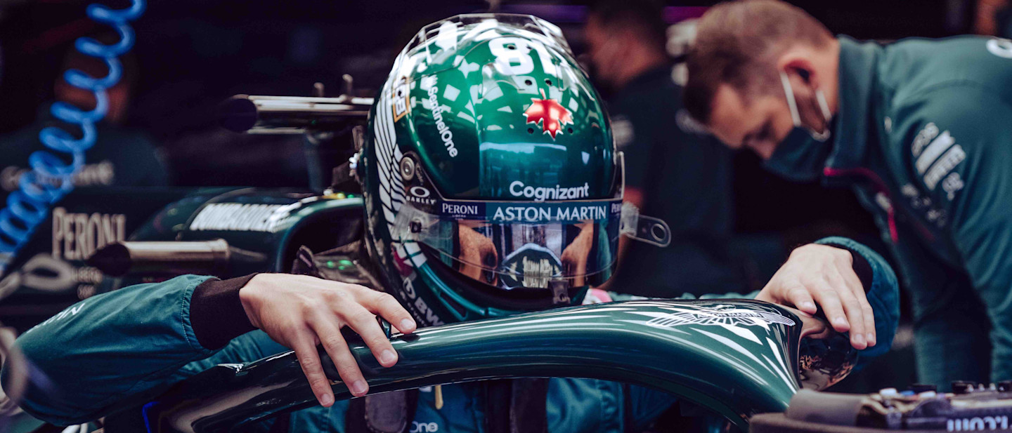 Lance Stroll climbs into the AMR21