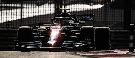 The sun bounces off the AMR21 as the sun sets ahead of the all-important FP2 session