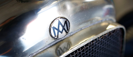 The original Aston Martin logo above the grille of the Green Pea.
